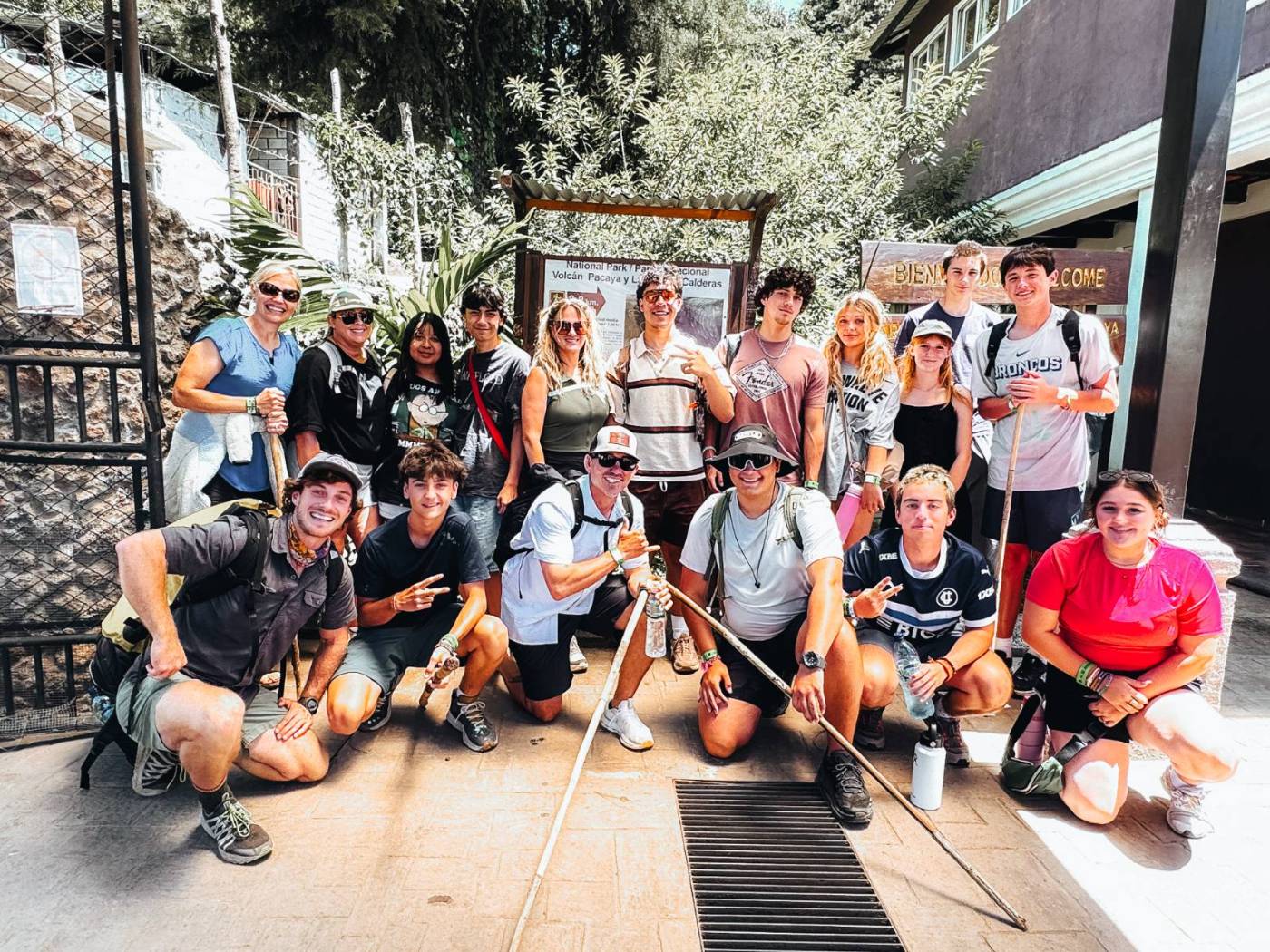 A student group and their guides gathered at a trailhead before a hike
