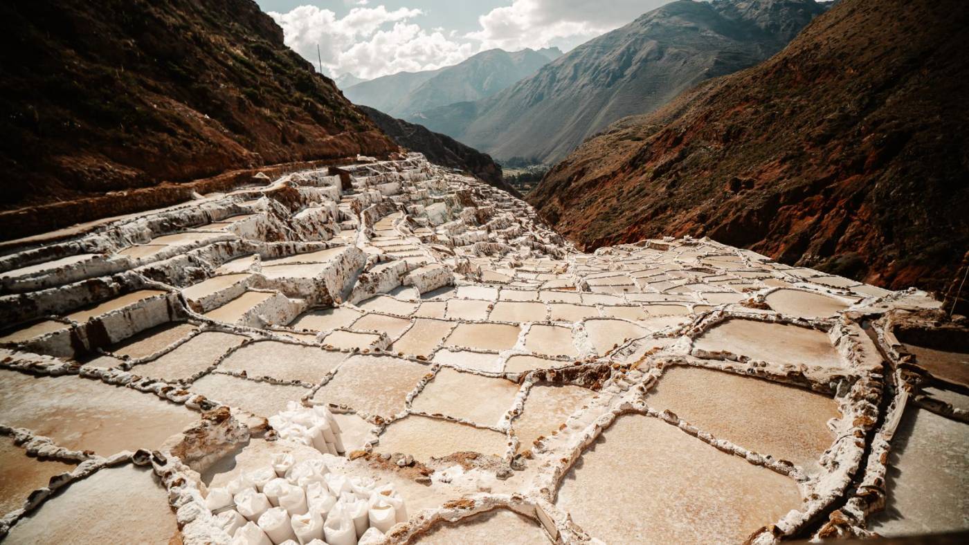 The Maras salt pans stepping down a red Andean valley in the Sacred Valley