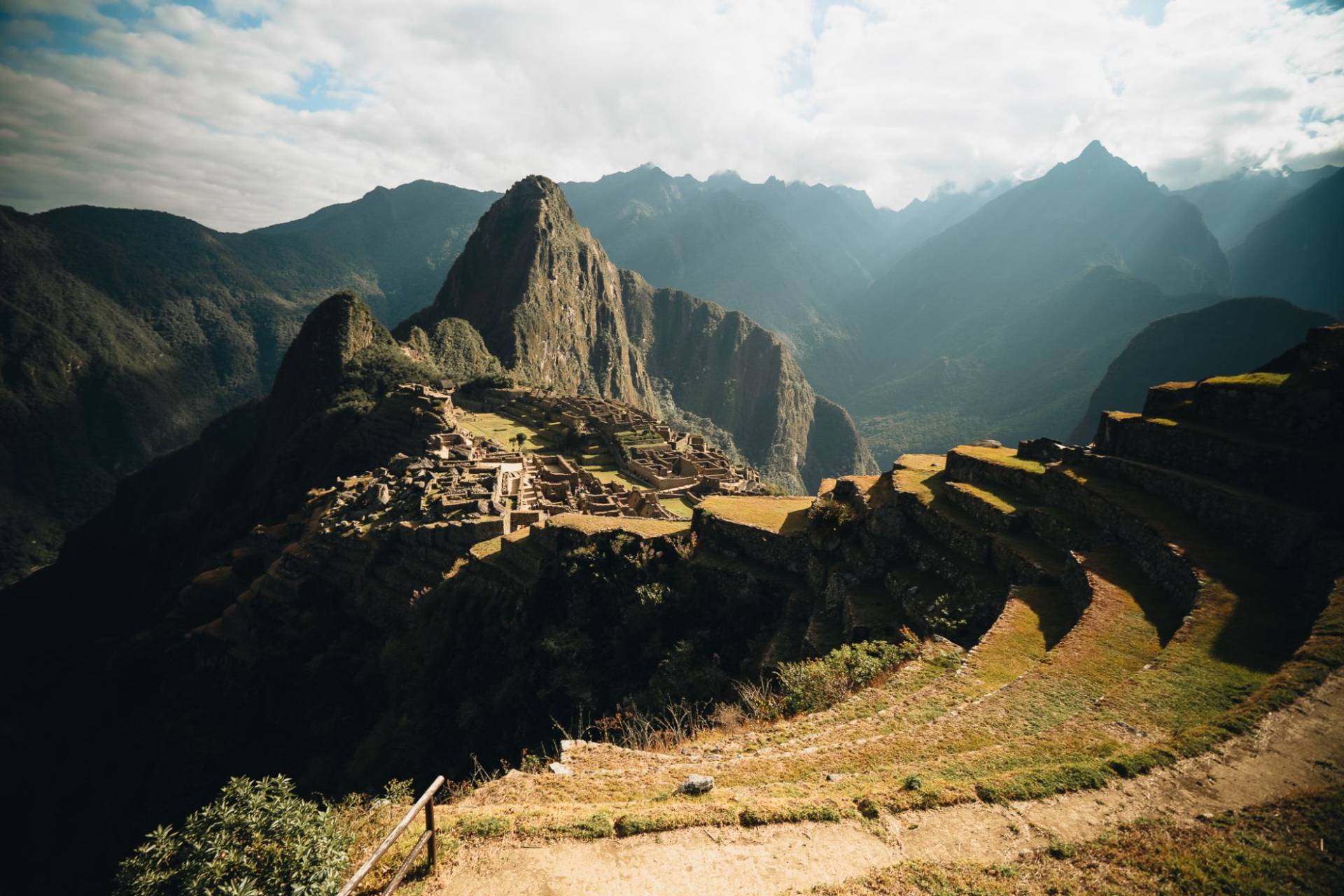 Machu Picchu and Huayna Picchu in late light, with terraces curving below