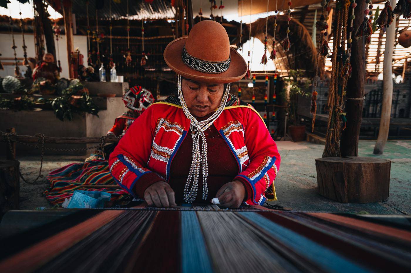 A Quechua weaver at a backstrap loom in the Sacred Valley