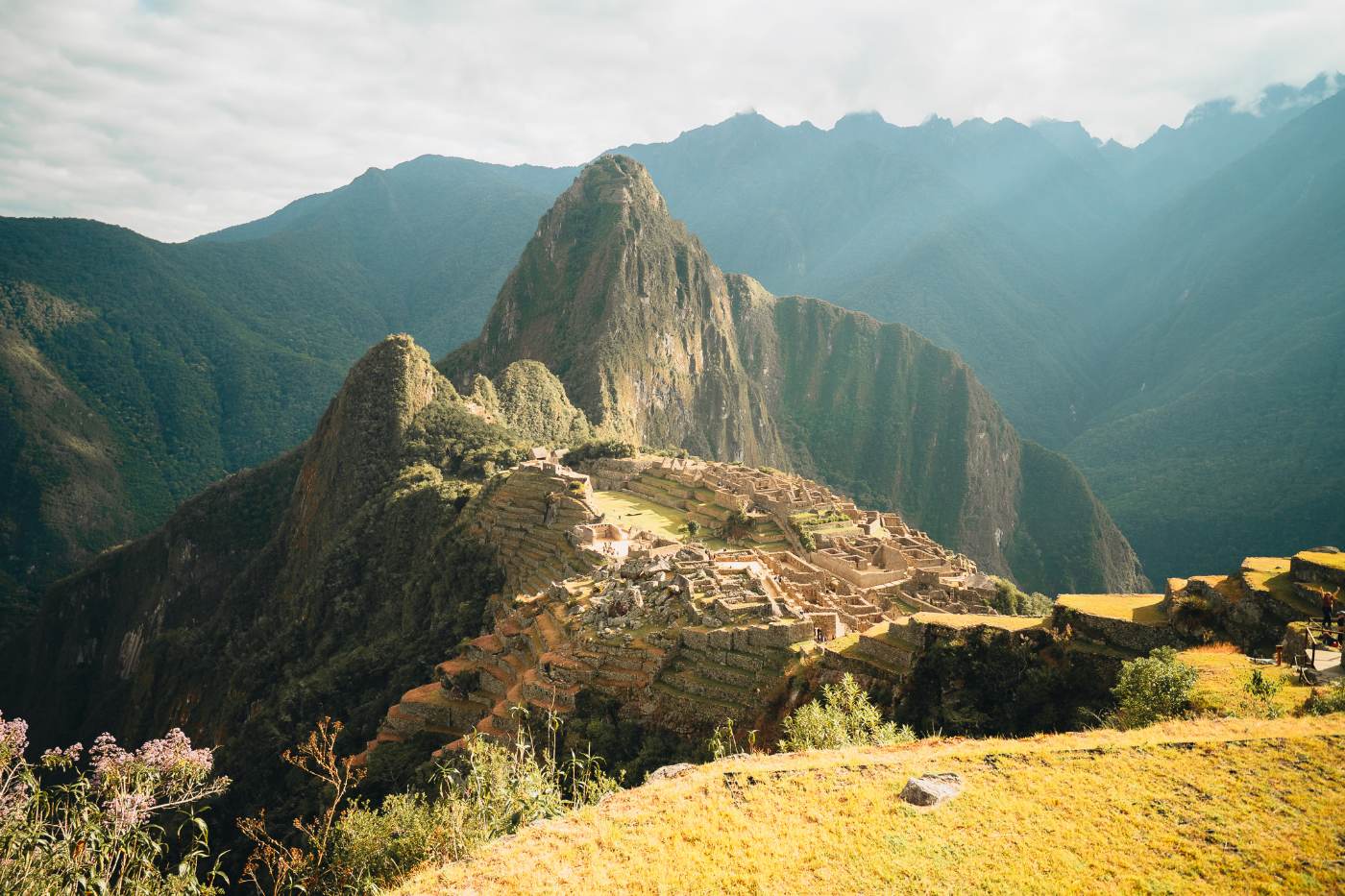 Machu Picchu and Huayna Picchu in morning light, terraces stepping down the ridge