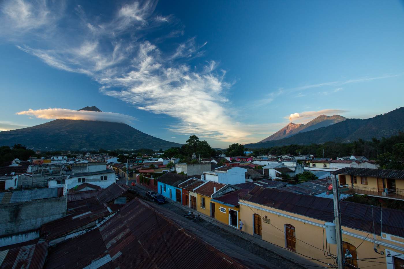 Antigua rooftops at dusk with Volcán de Agua and Fuego behind