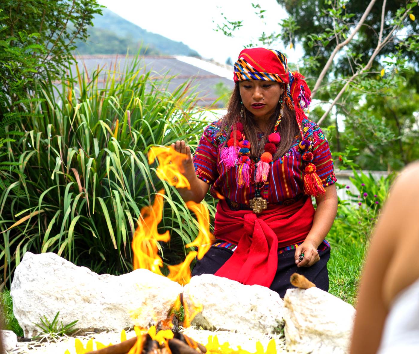 A Maya spiritual guide tending a ceremonial fire